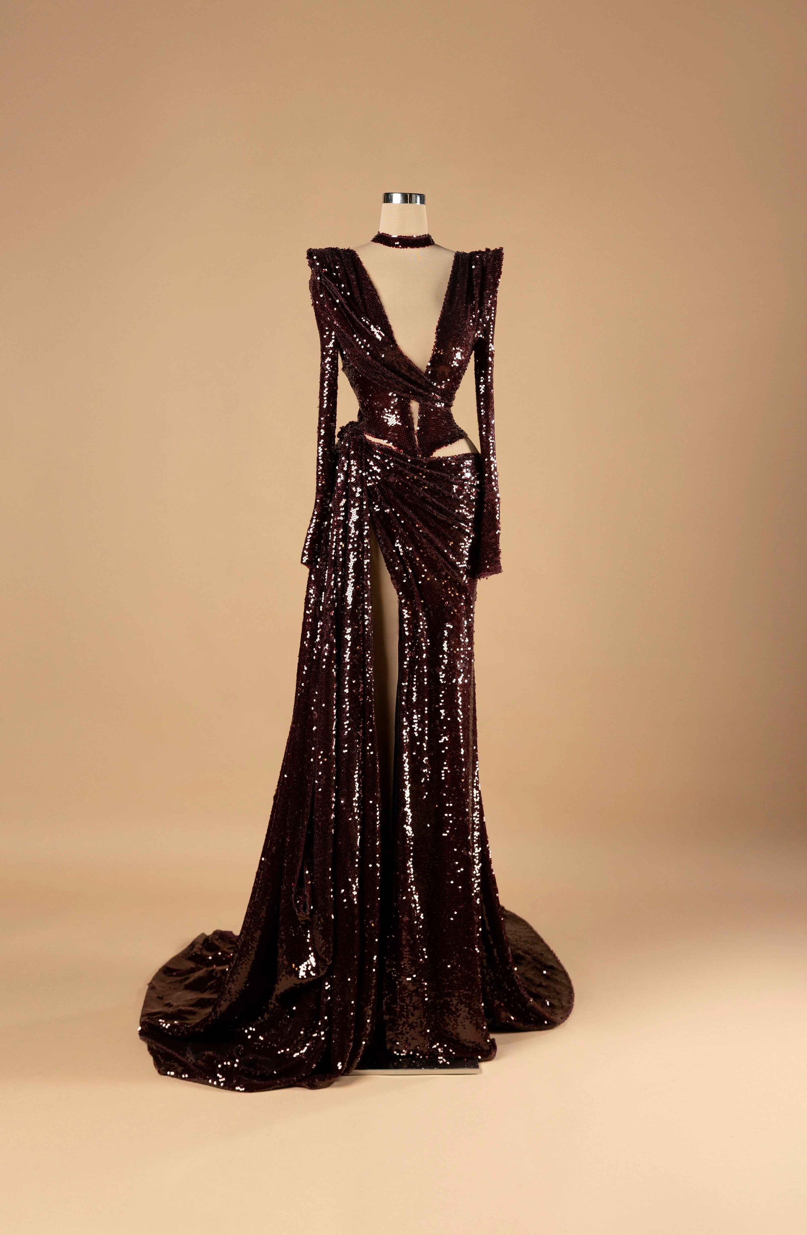 Sihëna Golden Sugar Reverie — burgundy deep-V long-sleeve sequin mermaid gown with choker neck, midriff cutouts, high slit and draped overskirt train.