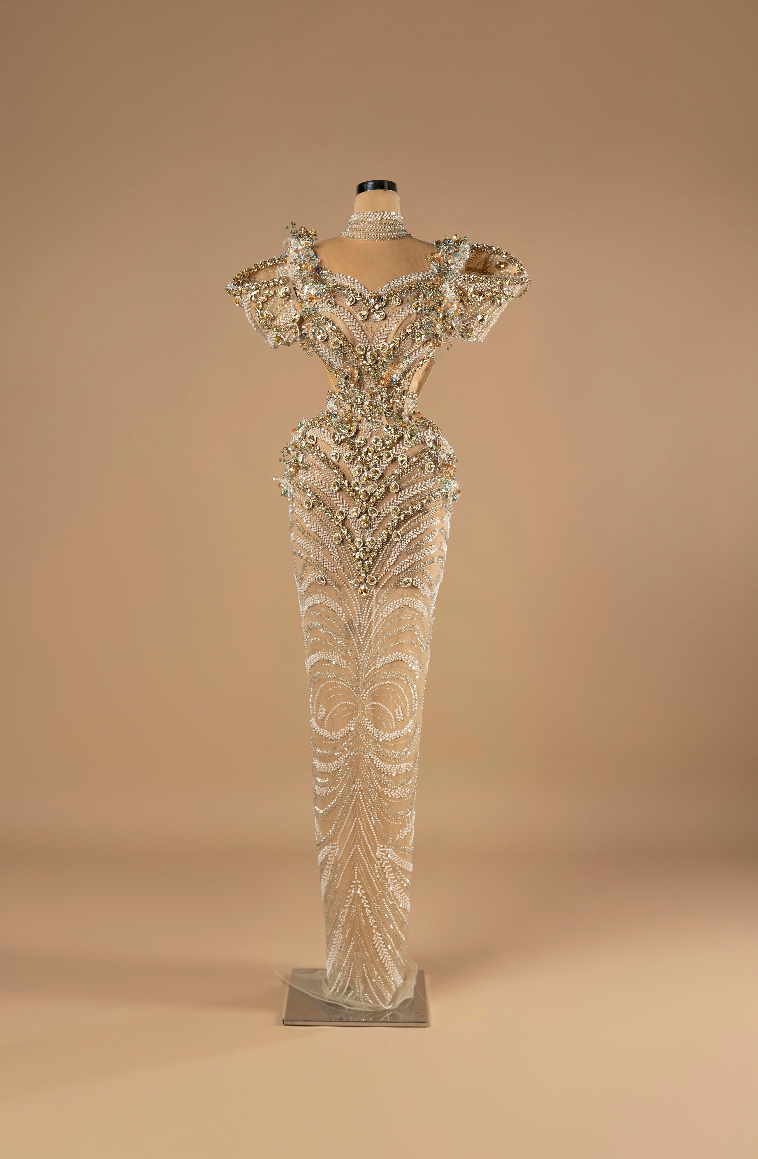 Sihëna Celestial Empress — ivory high-neck short-sleeve column gown with a pearl choker, gold beadwork and side cutouts.