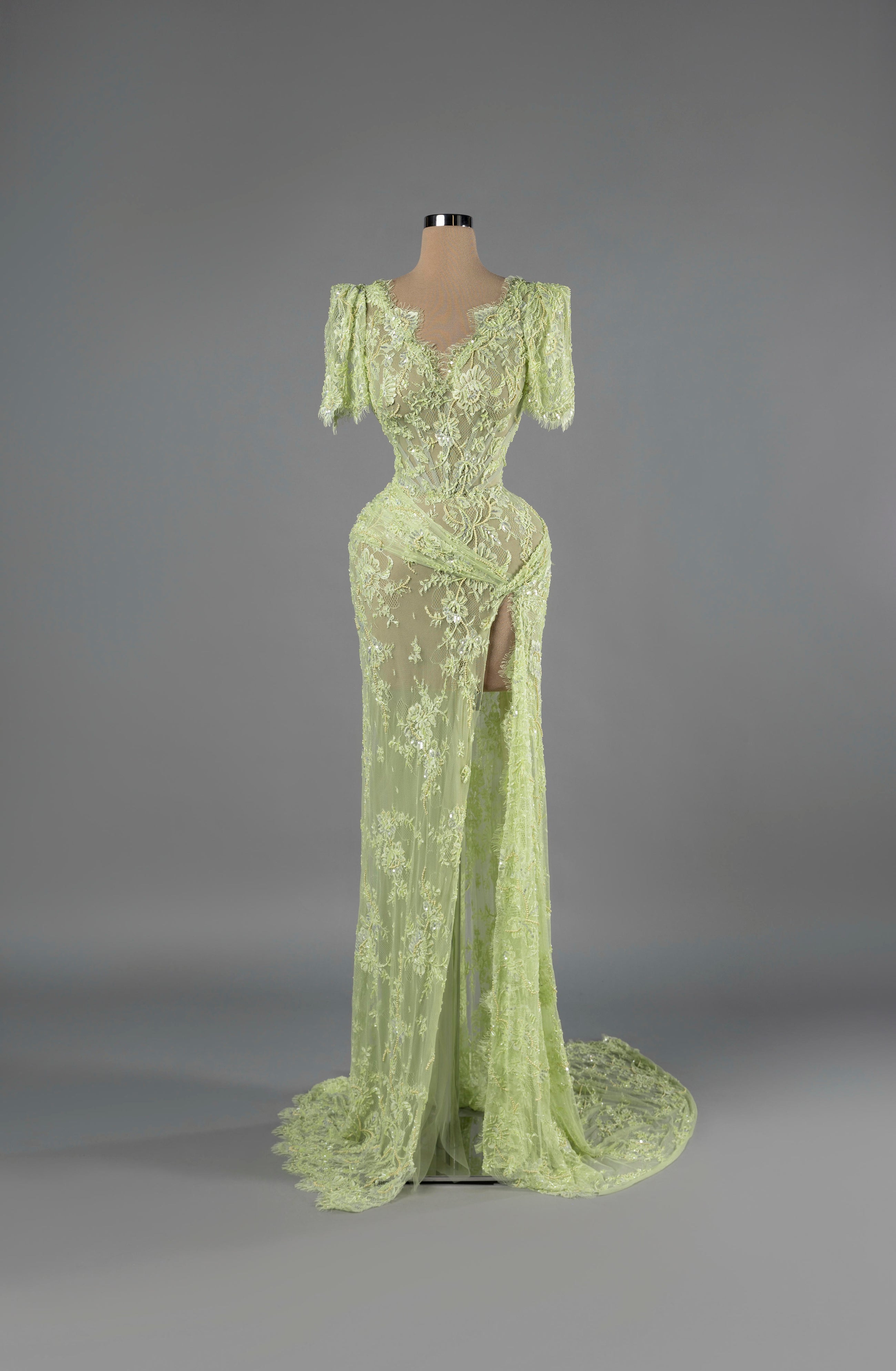Sihëna Celadon Whisper — sage-green V-neck short-sleeve lace mermaid gown with sequin and pearl beadwork and a high slit.