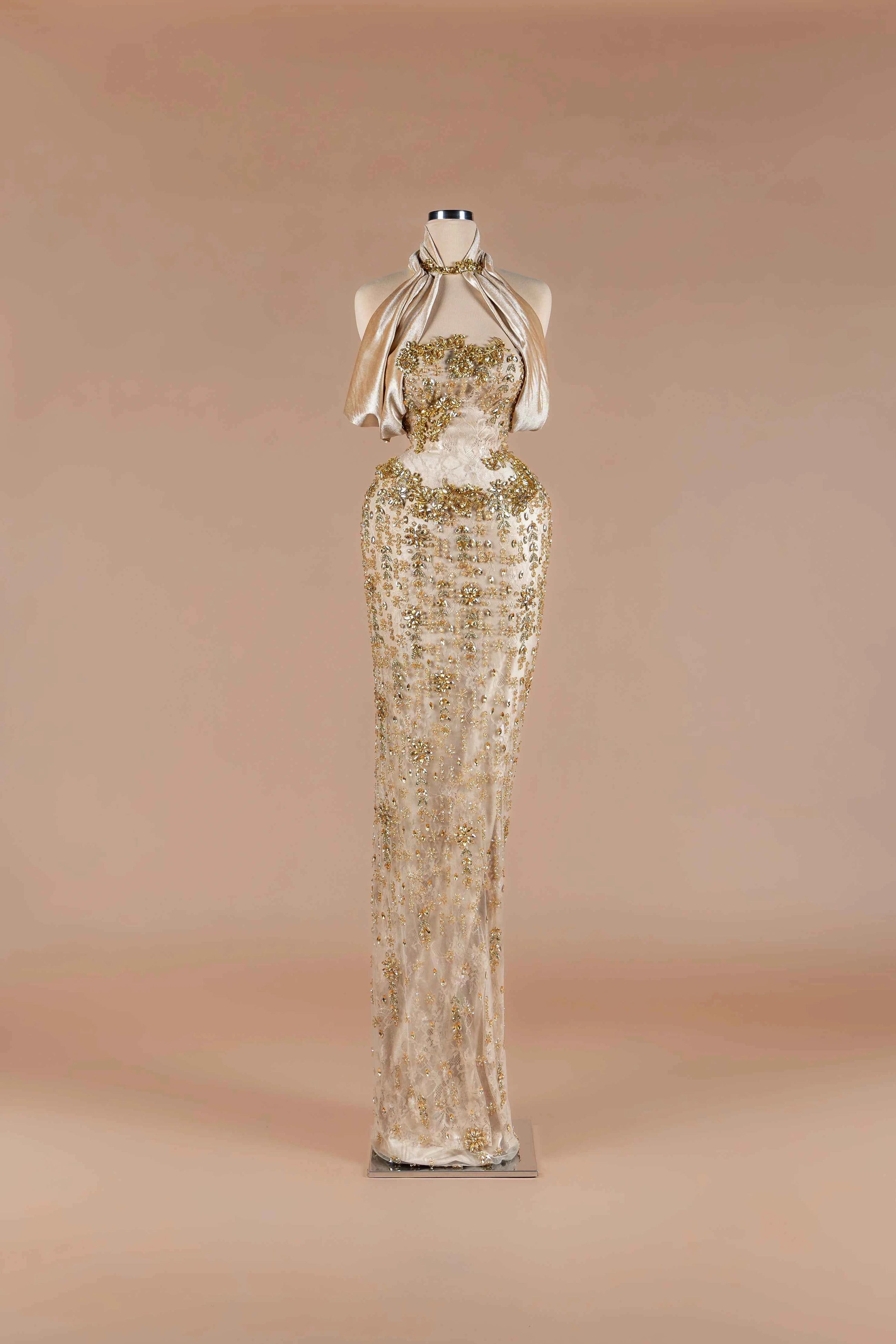 Sihëna Halcyon Shimmer — champagne strapless beaded-lace column gown with draped velvet neck wrap and crystal floral appliqué.