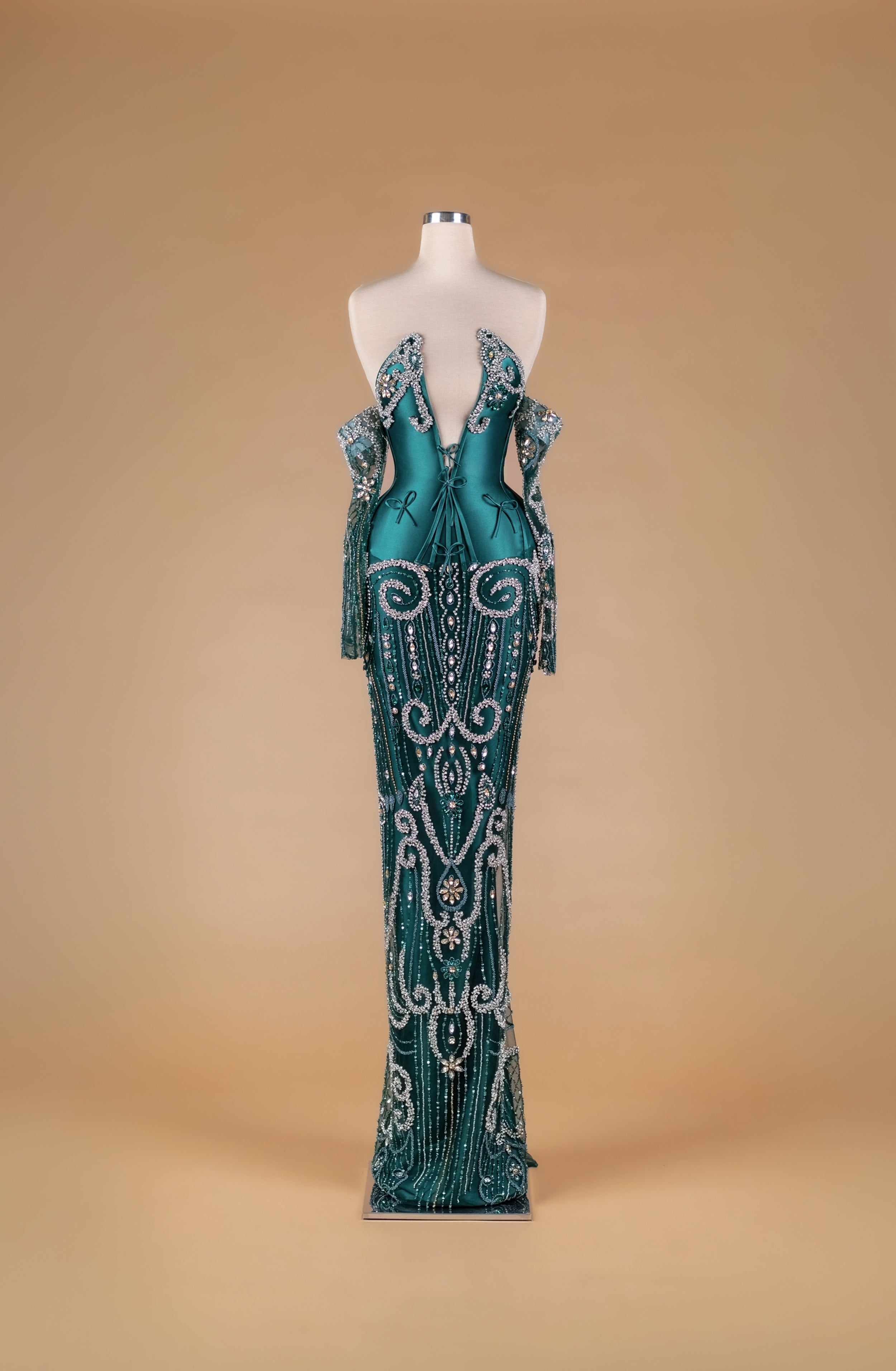 Sihëna Emerald Relic Radiance — emerald deep-v halter column gown with detached beaded sleeves and silver crystal scrollwork over emerald satin.