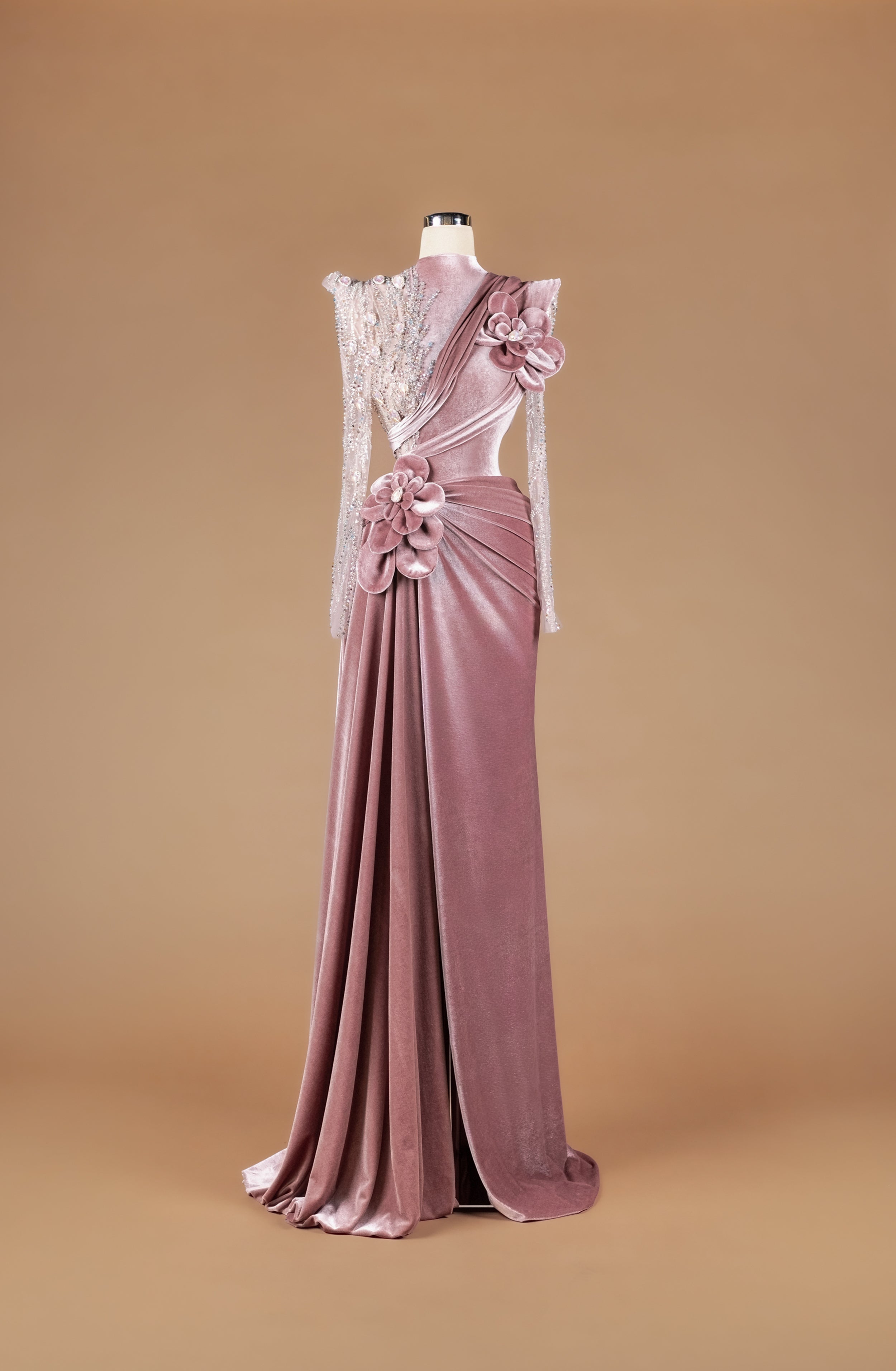 Sihëna Rose Velvet Garland — dusty-rose high-neck velvet column gown with sheer beaded illusion sleeve, 3D velvet roses and draped high-slit skirt.