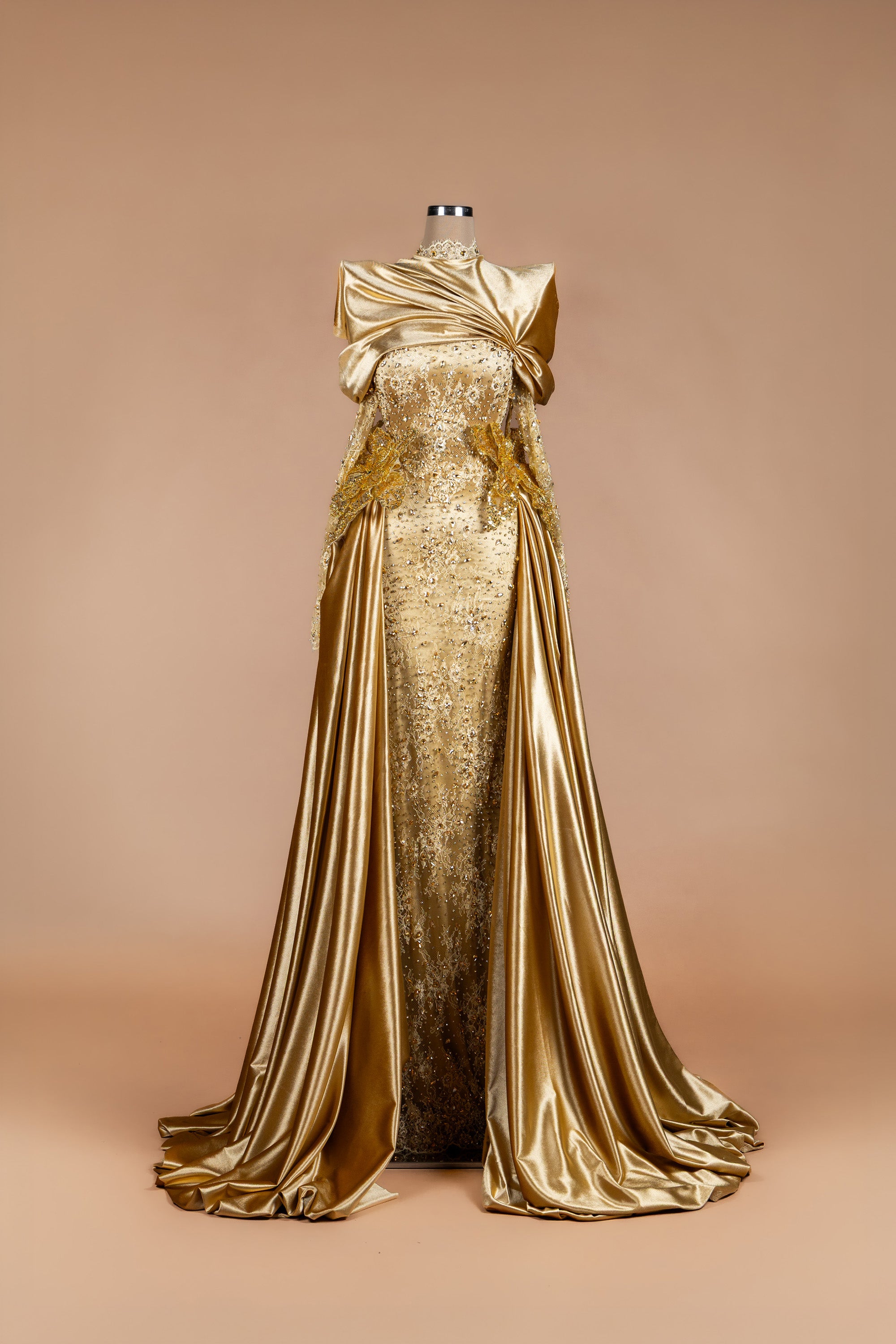 Sihëna Midas Dynasty — gold high-neck long-sleeve crystal-beaded lace column gown with draped satin overskirt and train.