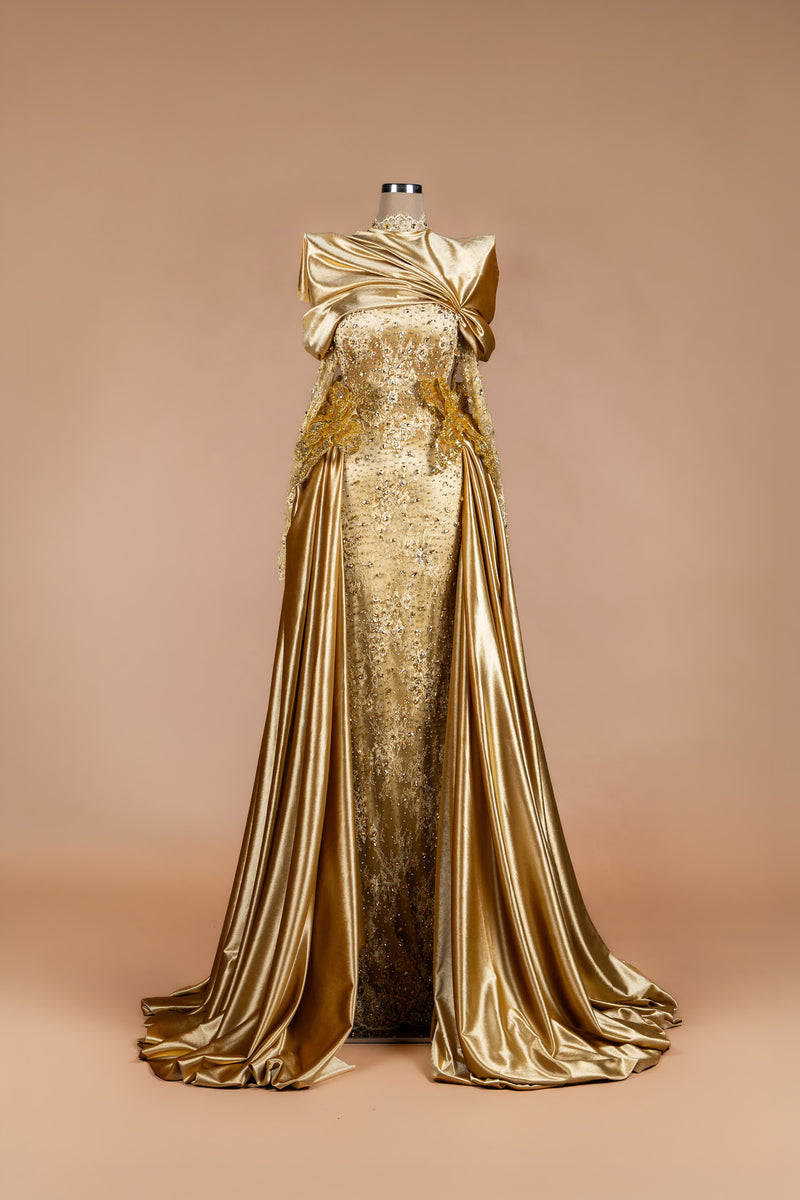 Sihëna Midas Dynasty — gold high-neck long-sleeve crystal-beaded lace column gown with draped satin overskirt and train.
