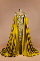 Sihëna Ochre Blossom Cape — marigold high-neck caped column gown with satin cape, crystal 3D florals and sheer beaded skirt.