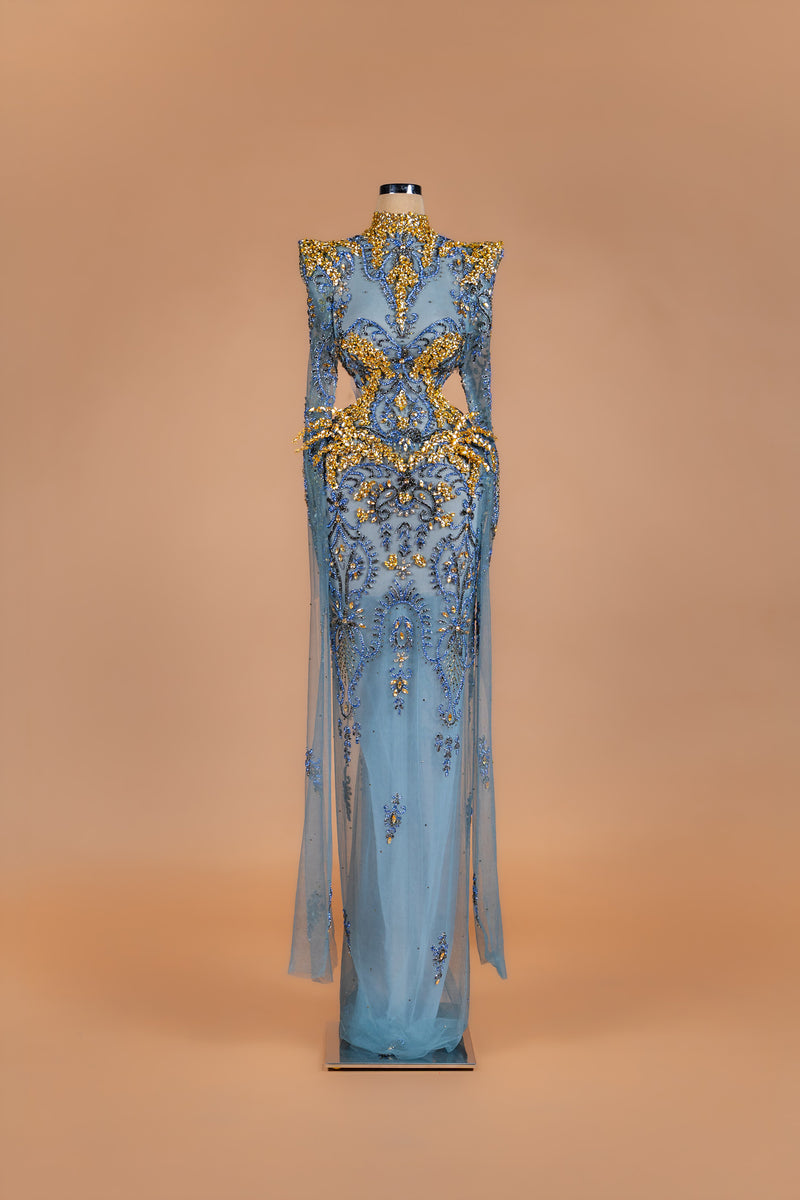 Sihëna Oasis Baroque — powder-blue high-neck long-sleeve sheer gown with gold and blue crystal baroque beadwork.