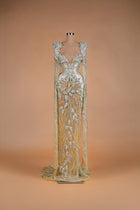 Sihëna Silver Wheat — champagne v-neck caped silver-crystal mermaid gown with beaded wheat motifs and sheer skirt.