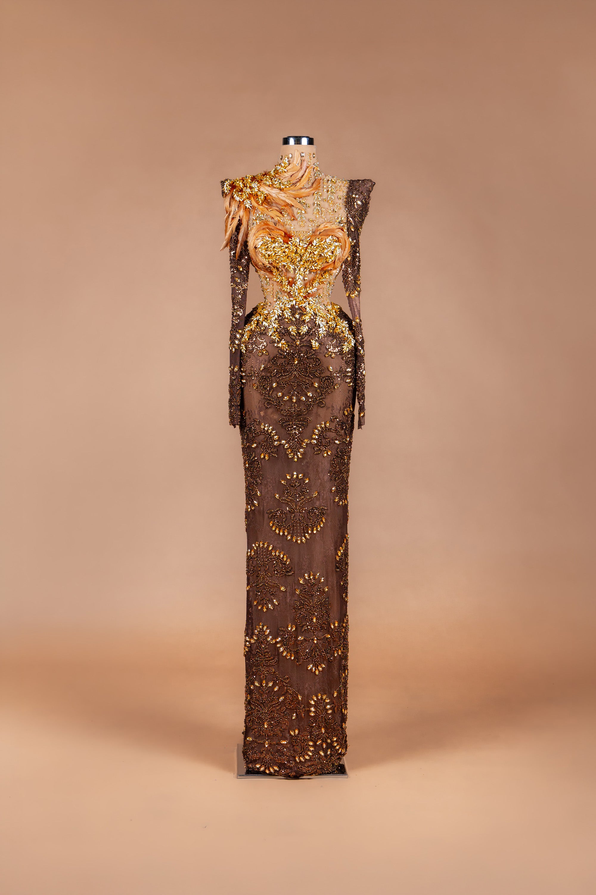 Sihëna Autumn Phoenix — chocolate high-neck long-sleeve illusion gown with gold beadwork, feather detail and beaded-lace skirt.