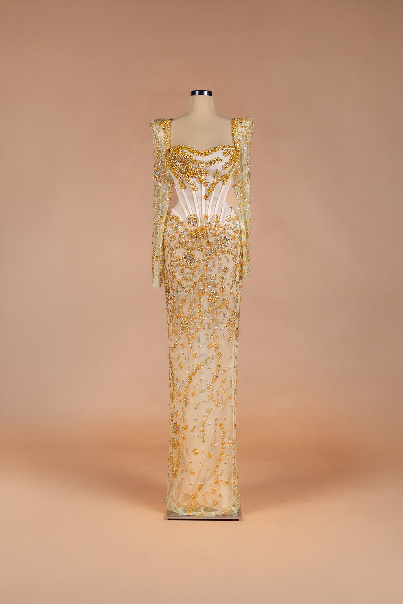 Sihëna Golden Starlight — champagne square-neck long-sleeve corset gown with gold crystal beadwork on sheer illusion base.