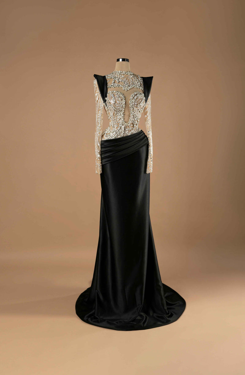 Sihëna Sheer Sculptural Sophistication — black high-neck long-sleeve mermaid gown with crystal-beaded sheer illusion bodice and draped black satin skirt and train.