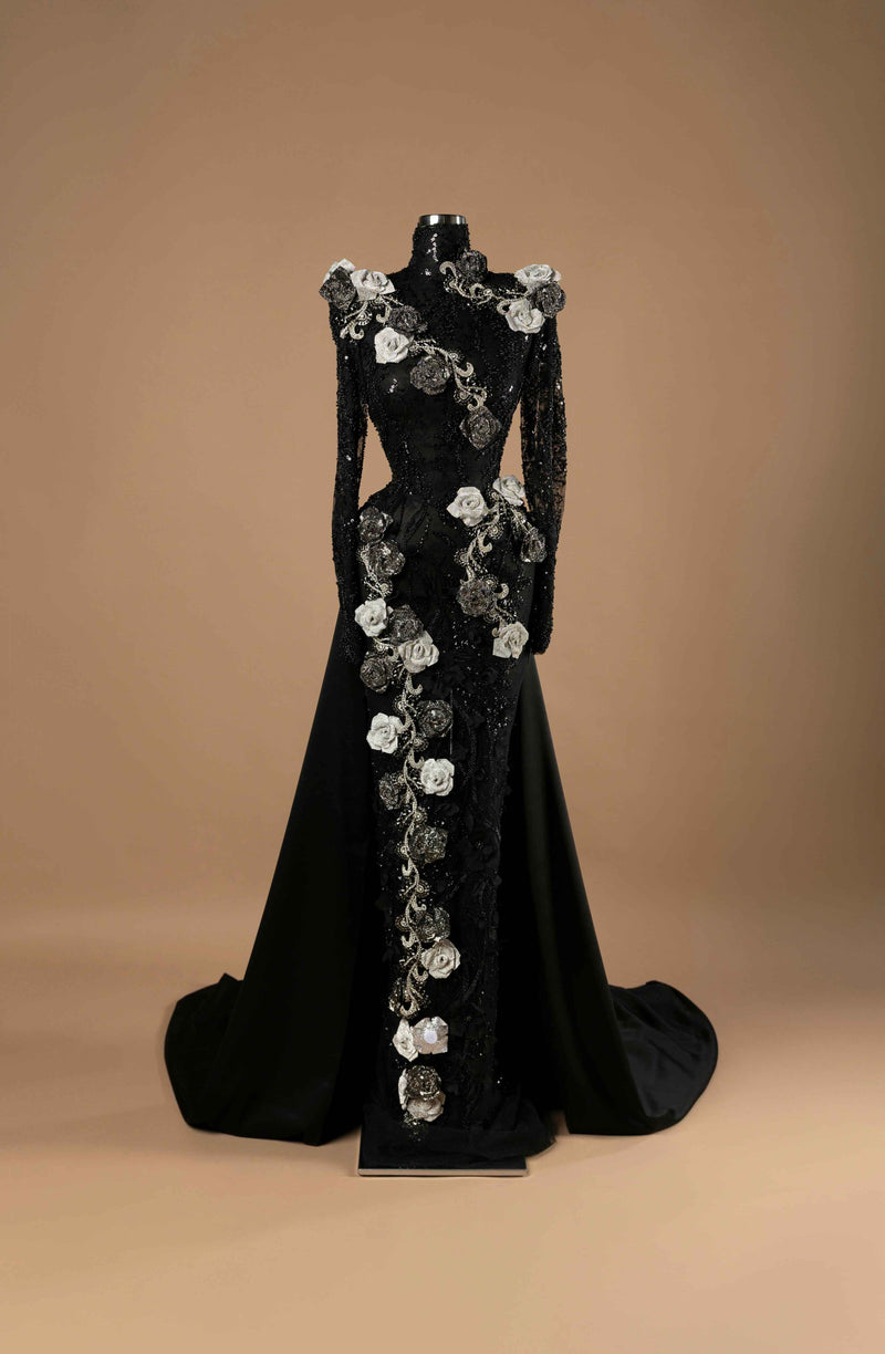 Sihëna Baroque Floral Drama — black high-neck long-sleeve mermaid gown with sequined lace, silver and black 3D rose appliqués and side overskirt train.