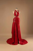 Sihëna Crimson Siren — red halter plunge sleeveless sequin mermaid gown with crystal-beaded waist trim, side cutouts, high slit and draped overskirt train.