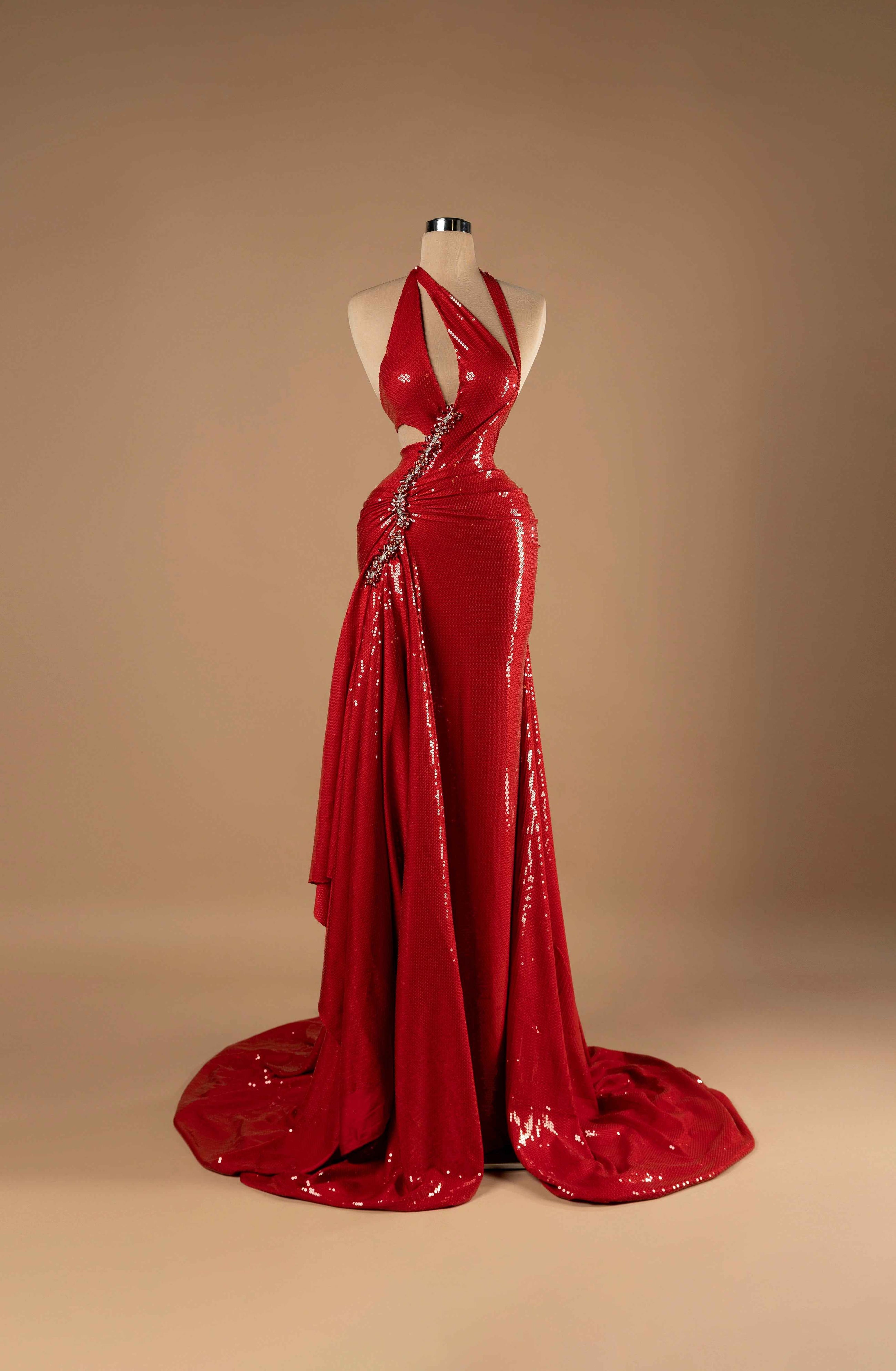 Sihëna Crimson Siren — red halter plunge sleeveless sequin mermaid gown with crystal-beaded waist trim, side cutouts, high slit and draped overskirt train.