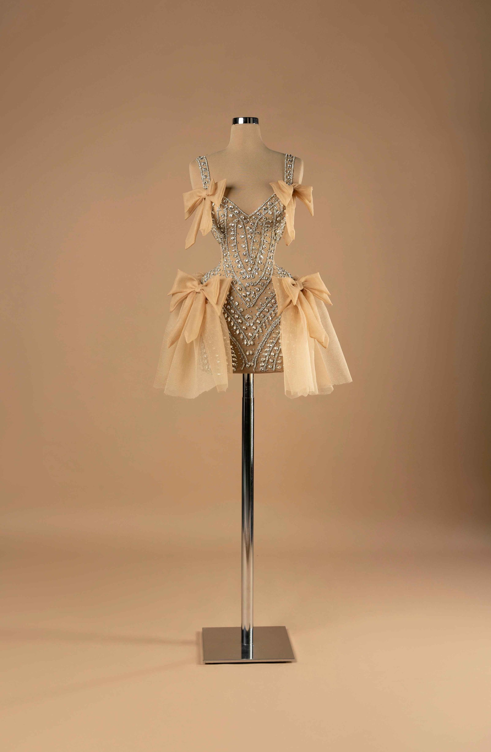 Sihëna Obsidian Allure — champagne sweetheart mini cocktail dress with crystal-beaded corset bodice on illusion tulle and champagne organza bows.