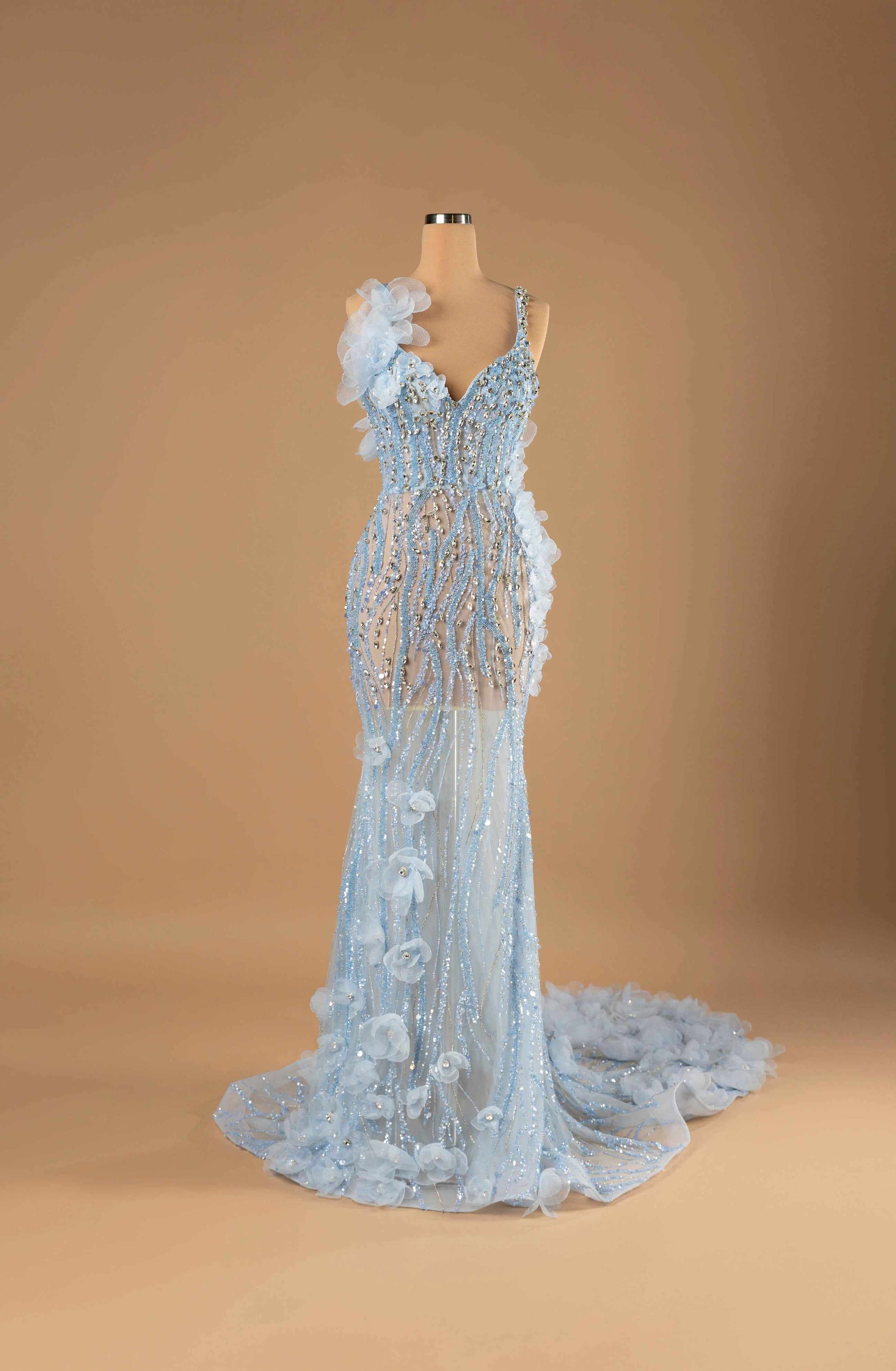 Sihëna Ice Blossom Symphony — powder-blue v-neck sleeveless mermaid gown with crystal beadwork on sheer net and powder-blue organza 3D florals.