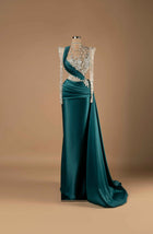 Sihëna Emerald Enchantment — emerald high-neck long-sleeve column gown with silver crystal-floral beadwork on illusion bodice and draped teal satin overskirt train.