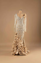 Sihëna Pearl Radiance — ivory v-neck long-sleeve mermaid gown with cascading pearl and crystal beadwork on illusion net and dramatic organza ruffle skirt.