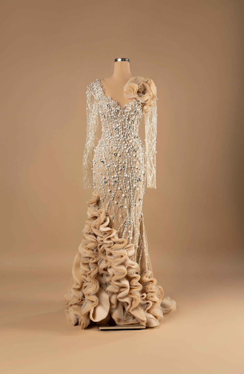 Sihëna Pearl Radiance — ivory v-neck long-sleeve mermaid gown with cascading pearl and crystal beadwork on illusion net and dramatic organza ruffle skirt.