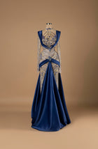 Sihëna Sapphire Majesty — navy high-neck long-sleeve A-line evening gown with sapphire and gold crystal beadwork over illusion bodice and draped satin overskirt.