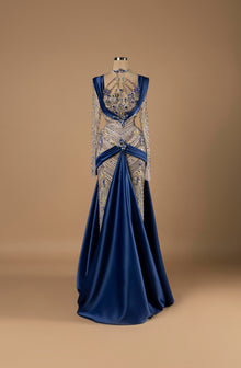 Sihëna Sapphire Majesty — navy high-neck long-sleeve A-line evening gown with sapphire and gold crystal beadwork over illusion bodice and draped satin overskirt.