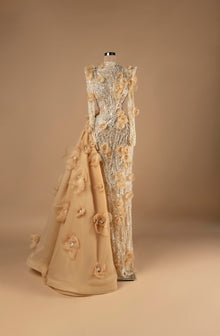 Sihëna Golden Blossom Cascade — champagne high-neck long-sleeve column evening gown with silver crystal beadwork, 3D organza florals and cascading overskirt train.