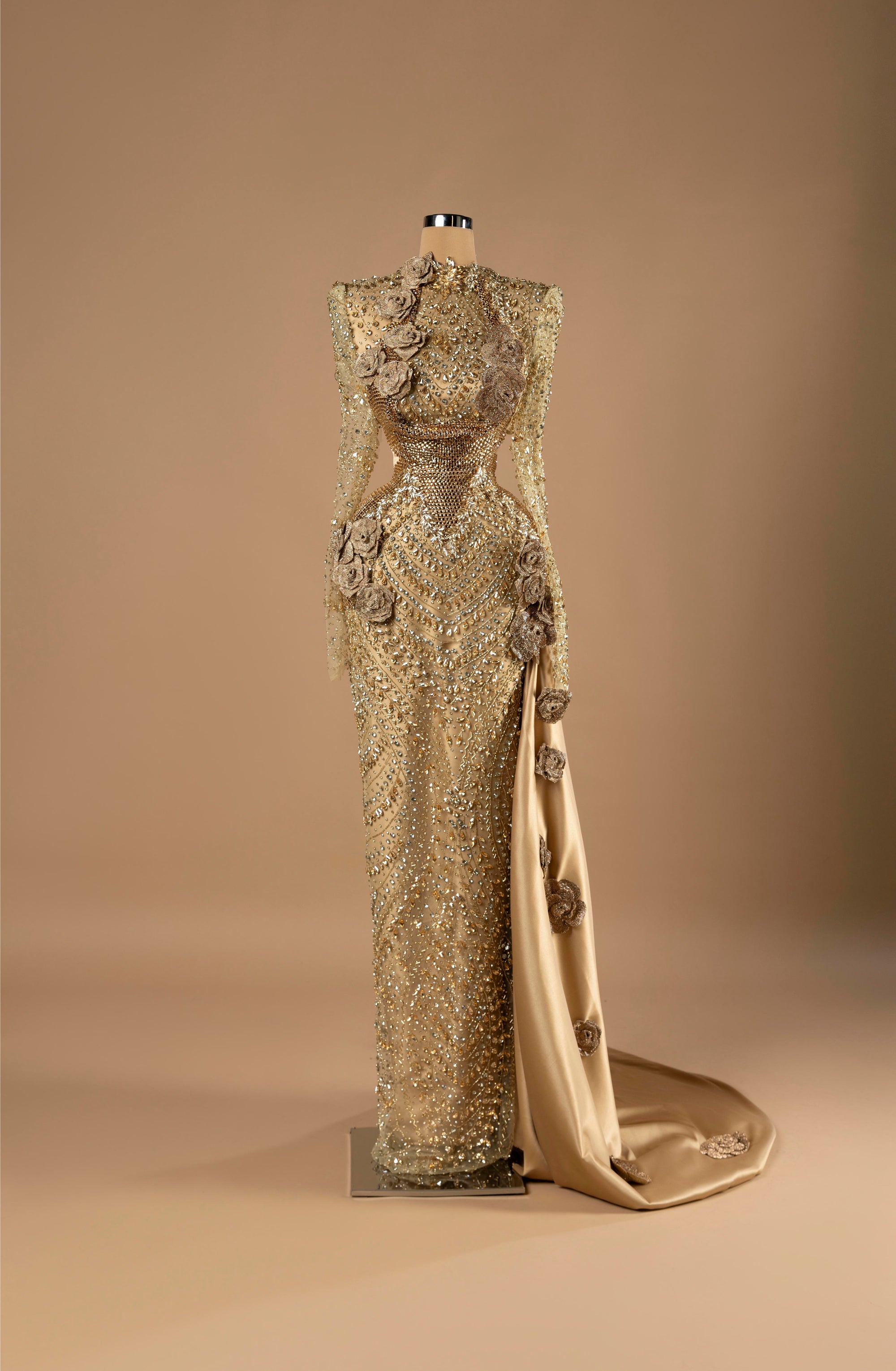 Sihëna Gilded Rose Empress — gold high-neck long-sleeve column gown with crystal-sequin beadwork and 3D-floral rosettes.