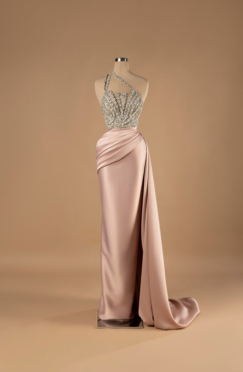 Sihëna Blush Radiance — blush one-shoulder column gown with a crystal-beaded sheer bodice and draped satin skirt with slit.