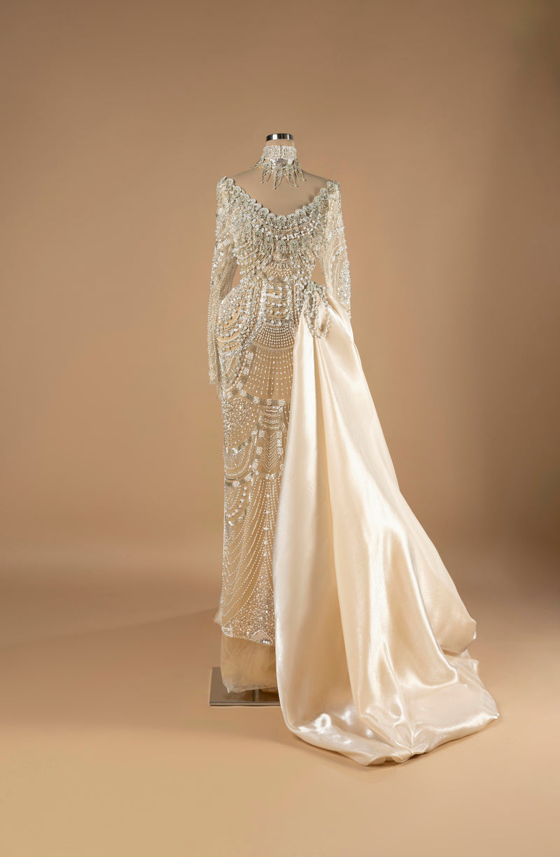 Sihëna Pearl Sovereign — ivory off-shoulder long-sleeve mermaid gown with pearl-crystal beadwork and a satin overskirt.