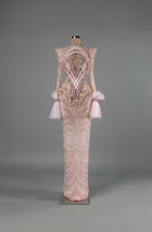 Sihëna Blush Enigma — blush high-neck long-sleeve column gown with pearl-crystal beadwork, a chest cutout and tulle cuffs.