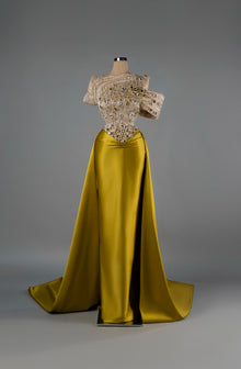 Sihëna Golden Majesty — gold off-shoulder mermaid gown with a crystal-beaded sheer bodice and a satin overskirt and slit.