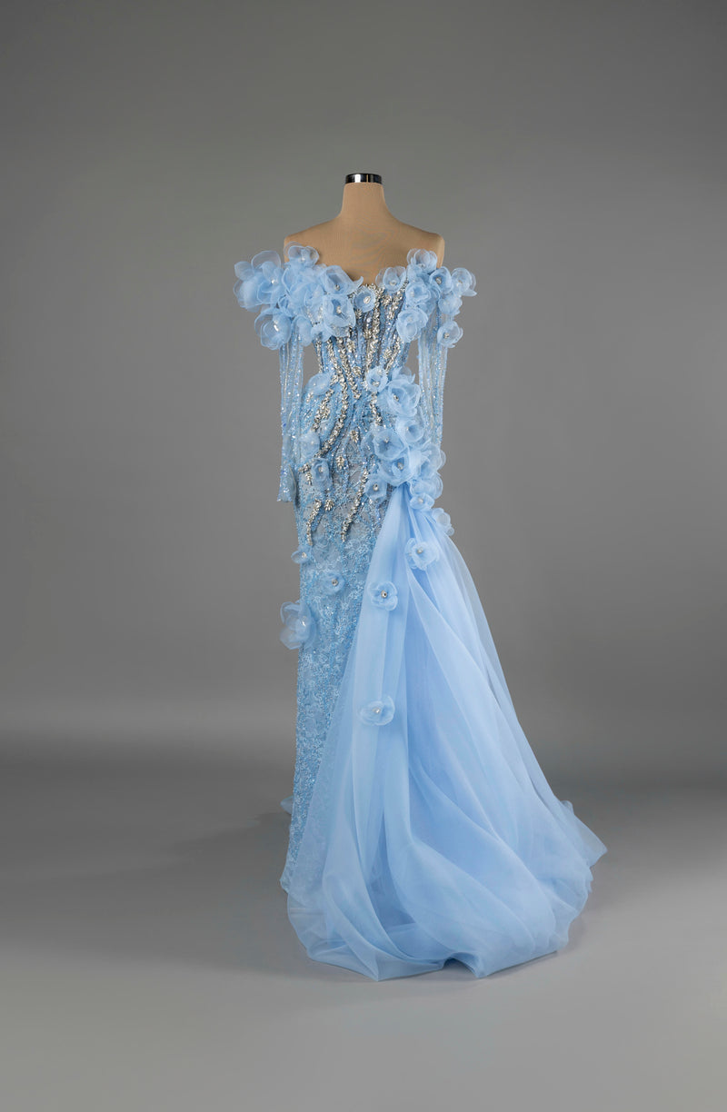 Sihëna Sky Blossom — powder-blue off-shoulder mermaid gown with 3D organza florals, crystal beadwork and a tulle overskirt.