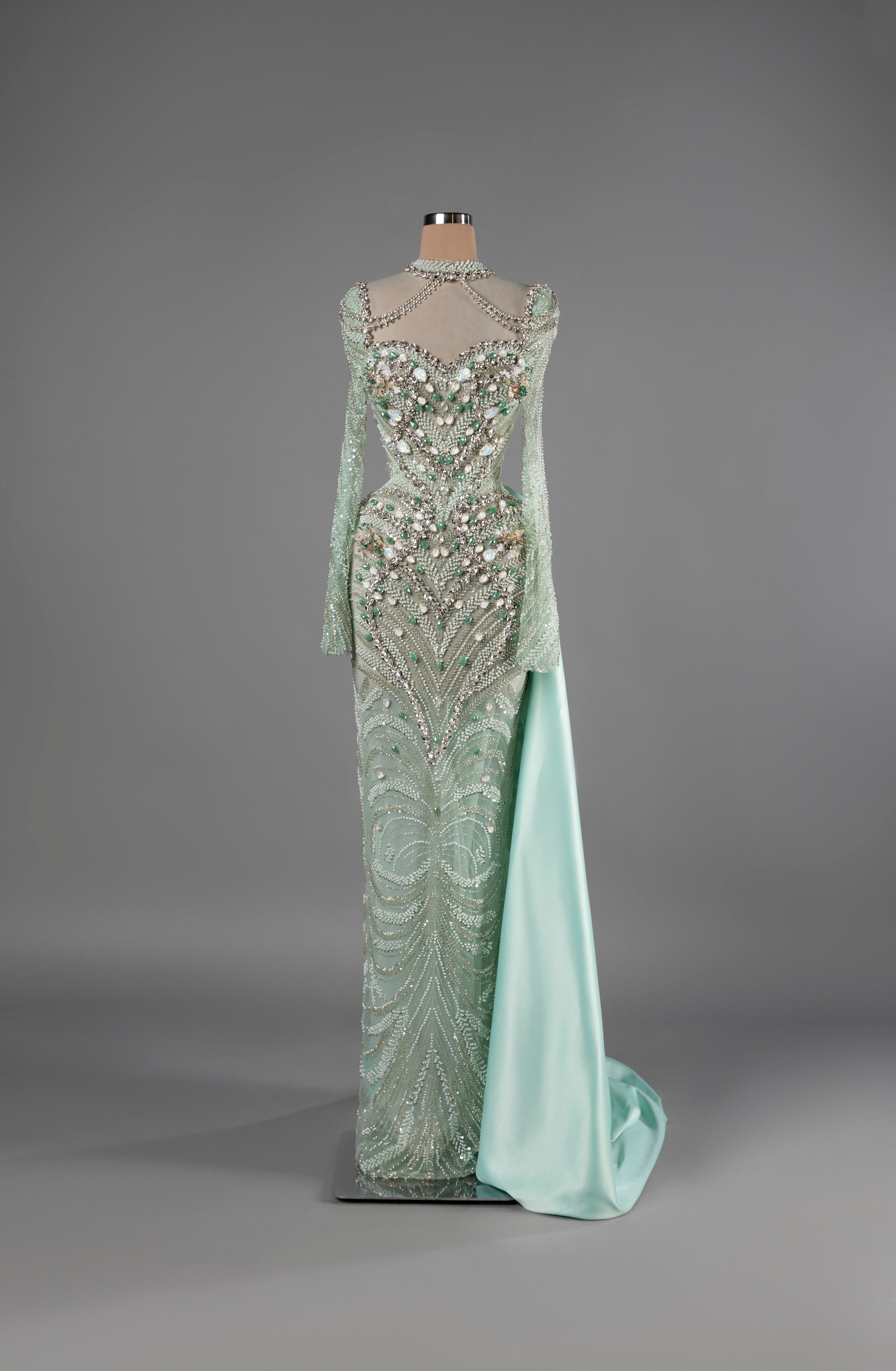 Sihëna Aqua Aurora — mint high-neck long-sleeve mermaid gown with crystal-pearl beadwork on sheer net and satin overskirt.