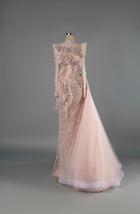 Sihëna Rose Mirage — blush high-neck long-sleeve mermaid gown with crystal beadwork and feather trim on sheer net.