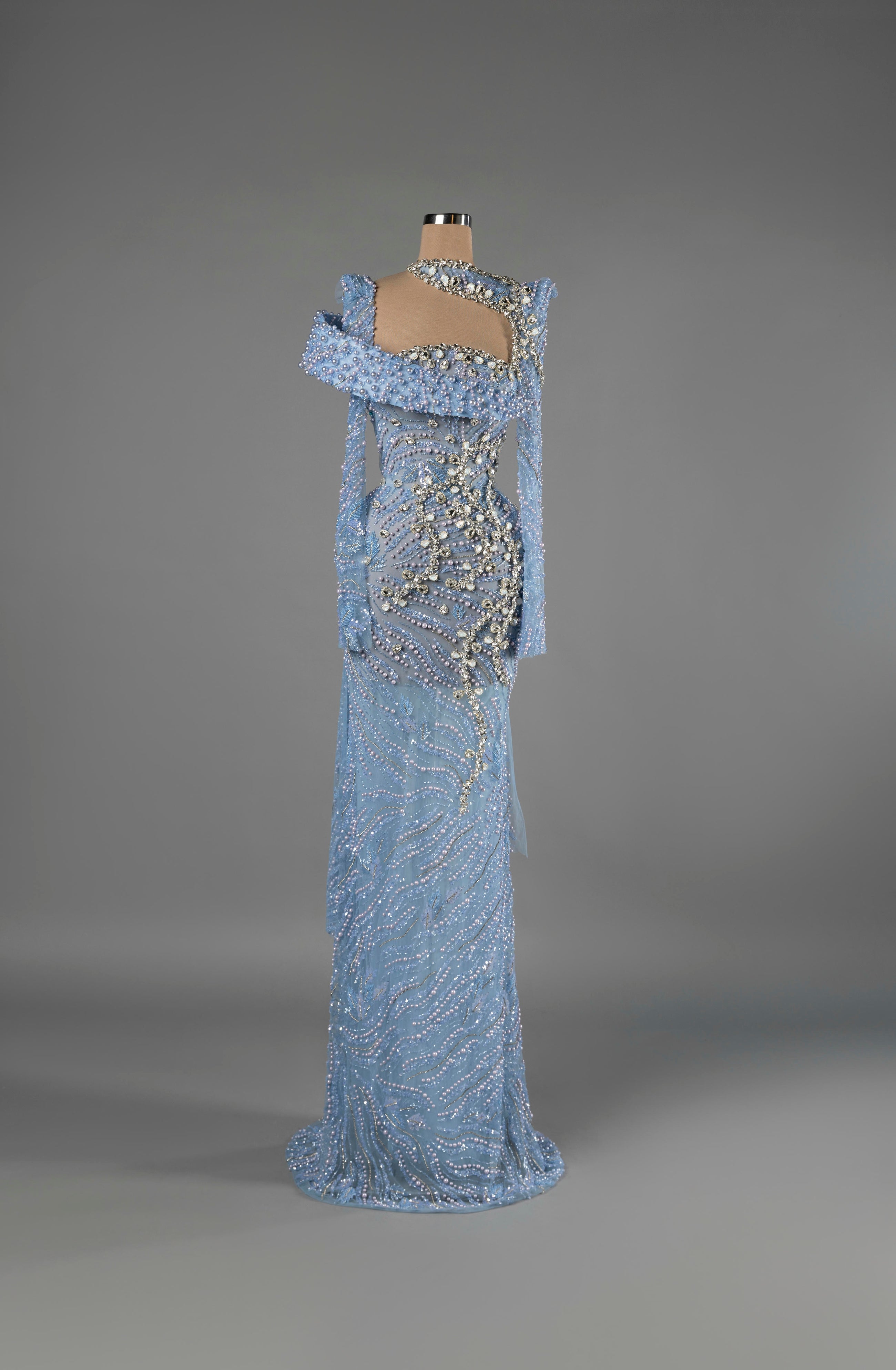 Sihëna Moonlit Tide — powder-blue one-shoulder long-sleeve column gown with pearl and crystal beadwork on sheer net.