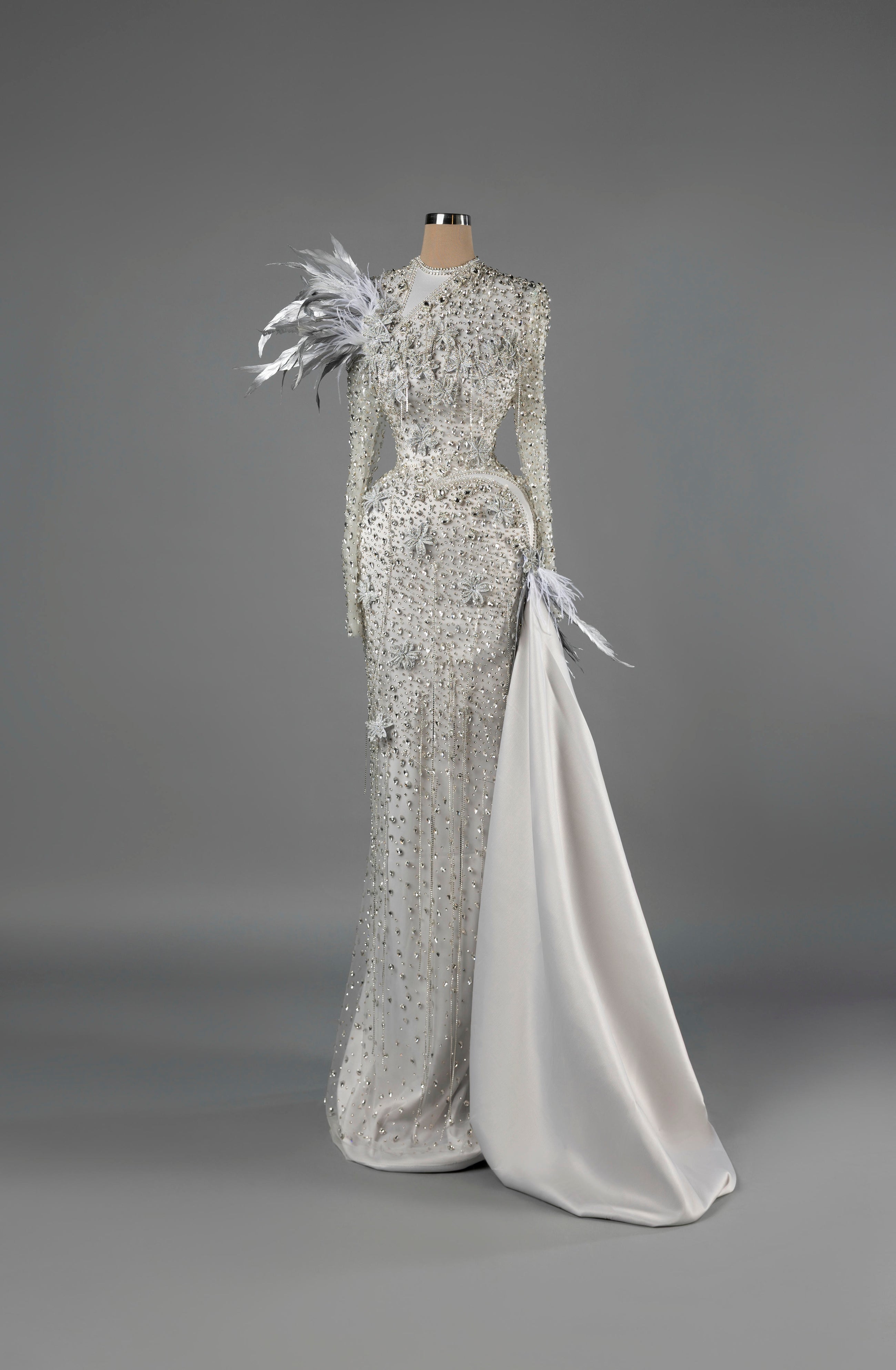 Sihëna Frosted Starlight — white high-neck long-sleeve mermaid gown with crystal-pearl beadwork and satin overskirt.
