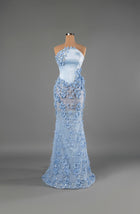 Sihëna Aster Frost — powder-blue strapless asymmetric mermaid gown in satin with 3D floral appliqué, crystals and sheer beaded skirt.