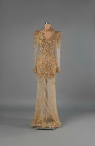 Sihëna Sunlit Diadem — gold high-neck long-sleeve mermaid gown with crystal and sequin beadwork on sheer tulle and beaded swag skirt.