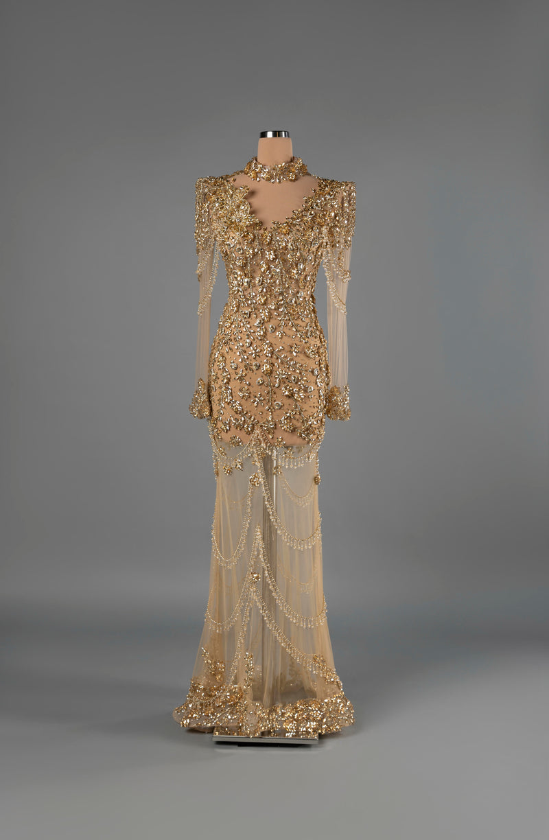Sihëna Sunlit Diadem — gold high-neck long-sleeve mermaid gown with crystal and sequin beadwork on sheer tulle and beaded swag skirt.