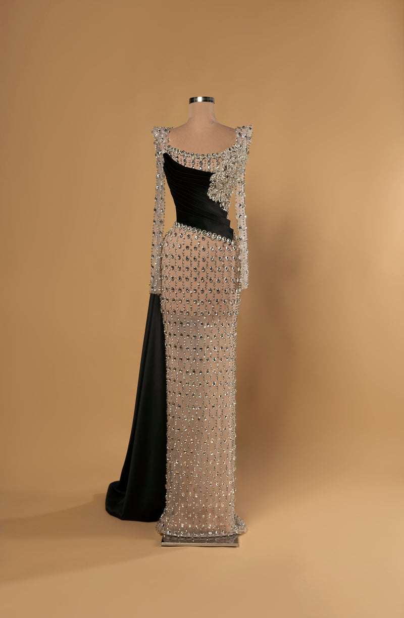Sihëna Noir Prism — black column gown with crystal-beaded sheer bodice, draped black satin bust panel and crystal-studded skirt with side train.