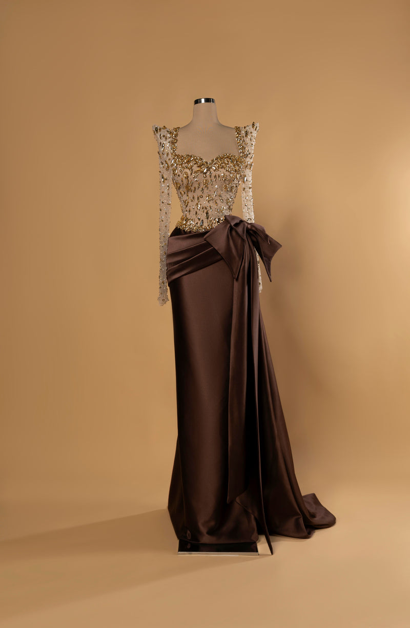 Sihëna Golden Mocha — mocha-brown column gown with gold crystal beaded illusion bodice and draped satin wrap skirt with bow.