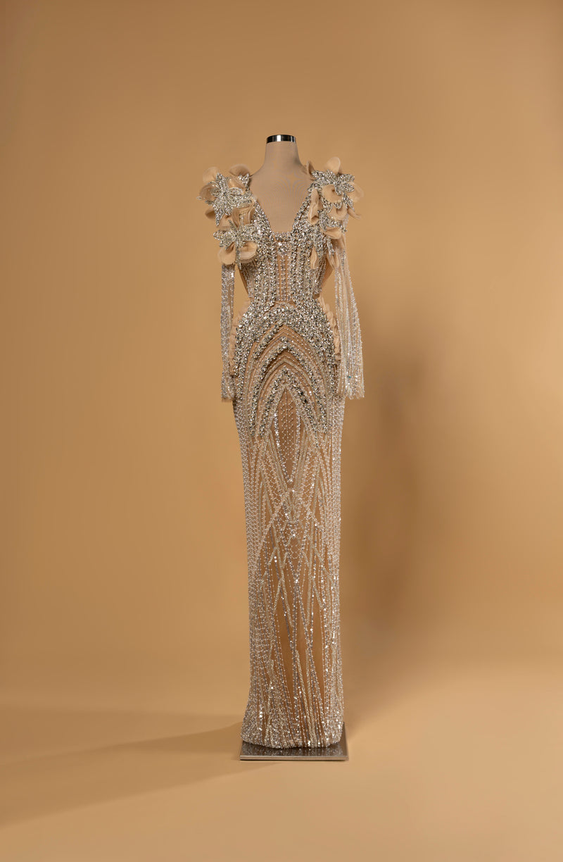 Sihëna Opaline Arches — nude deep-v long-sleeve column gown with arched crystal and pearl beadwork and 3D floral beaded shoulders.