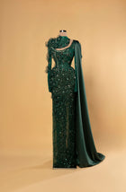 Sihëna Malachite Aura — emerald high-neck long-sleeve mermaid gown with teardrop crystal beadwork, 3D ruffle florals and one-shoulder satin cape drape.