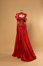 Sihëna Ruby Sultana — red high-neck long-sleeve mermaid evening gown in satin and lace with beaded illusion corset and draped overskirt.