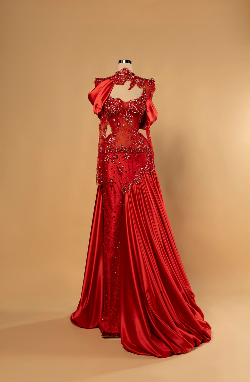 Sihëna Ruby Sultana — red high-neck long-sleeve mermaid evening gown in satin and lace with beaded illusion corset and draped overskirt.