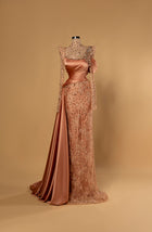 Sihëna Amber Monarch — amber high-neck long-sleeve column evening gown in satin with crystal illusion yoke, draped bodice and overskirt.