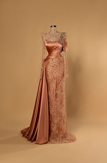 Sihëna Amber Monarch — amber high-neck long-sleeve column evening gown in satin with crystal illusion yoke, draped bodice and overskirt.