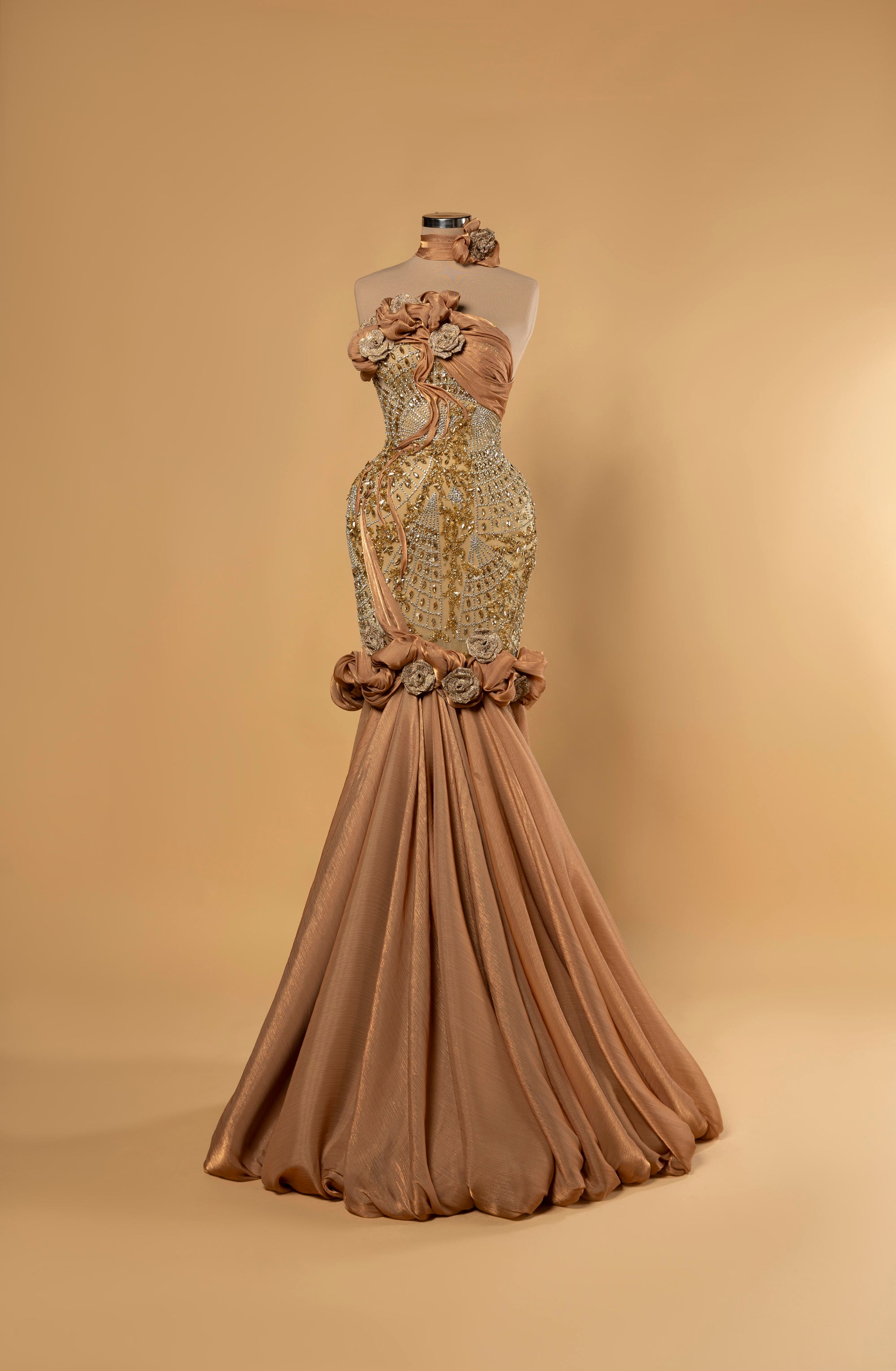 Sihëna Sahara Rosette — copper strapless sleeveless mermaid evening gown with crystal-beaded illusion bodice, 3D rosettes and draped skirt.