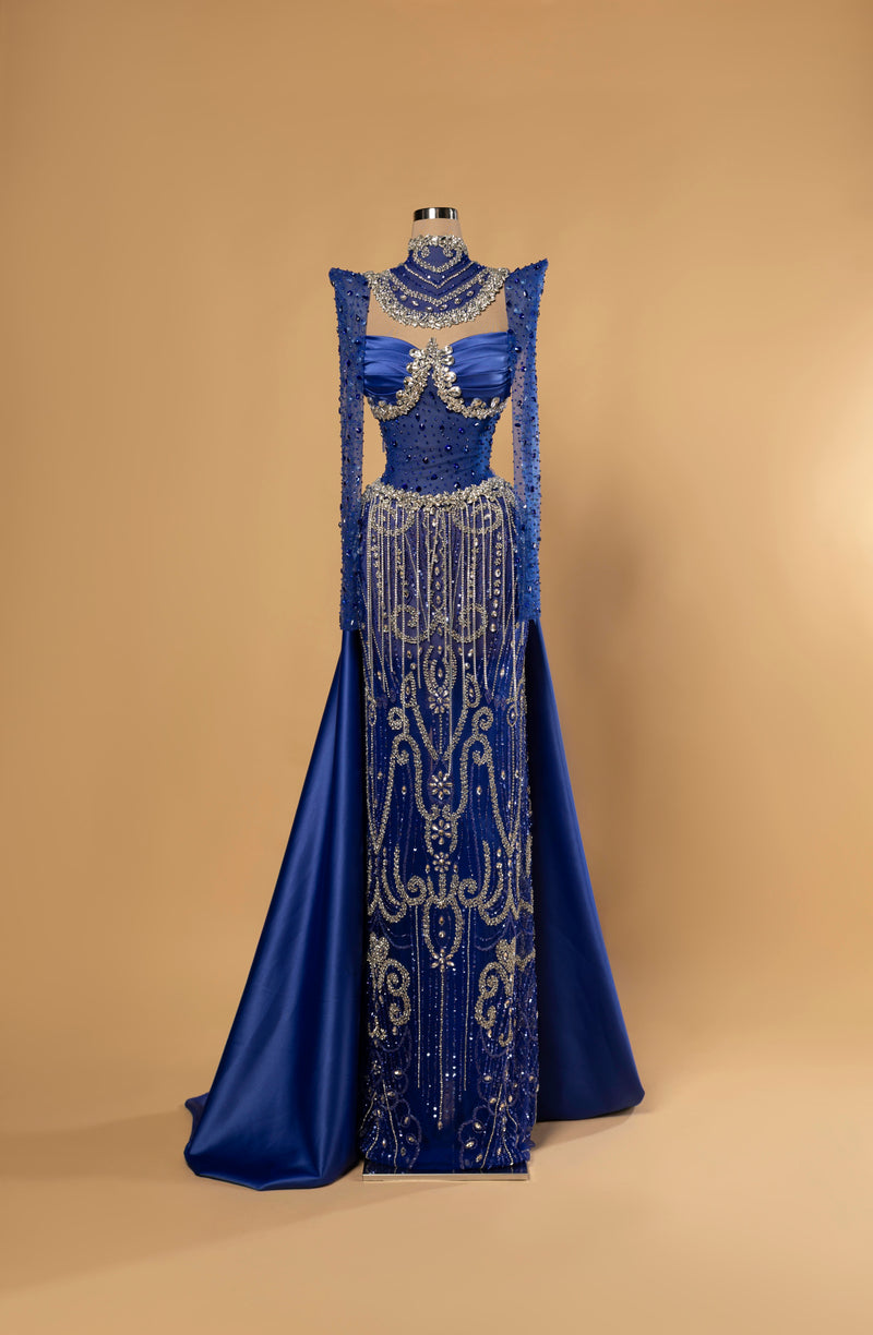Sihëna Cerulean Heirloom — cobalt high-neck long-sleeve mermaid evening gown in satin with crystal choker collar and beaded sheer skirt.