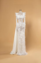 Sihëna Alabaster Halcyon — ivory high-neck long-sleeve mermaid bridal gown in lace with pearl-crystal corset, feathers and beaded sheer skirt.