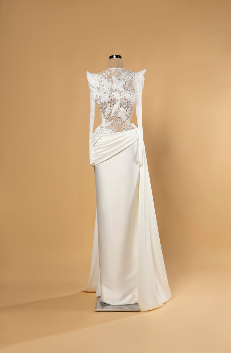 Sihëna Noor Draped Serenity — ivory high-neck long-sleeve column bridal gown in lace with pearl 3D-florals and draped matte skirt.